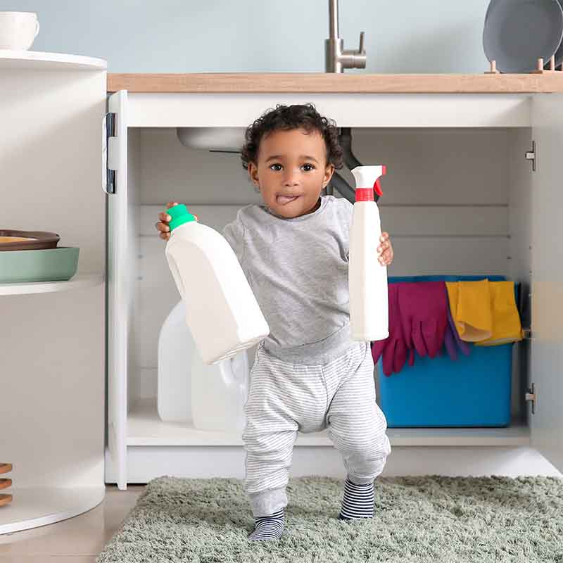 Toddler with cleaning supplies